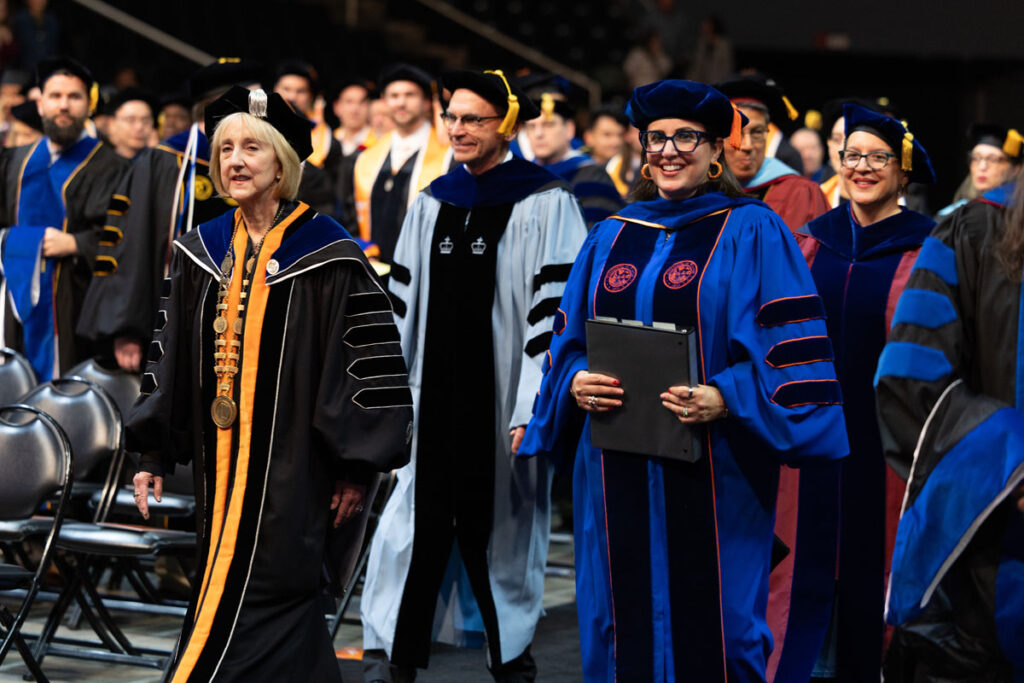 Chancellor Plowman, Provost Zomchick, Vice Provost and Dean of the Graduate School Van Puymbroeck, and Assistant Dean of the Graduate School, Vidal Pizarro processing into the arena.