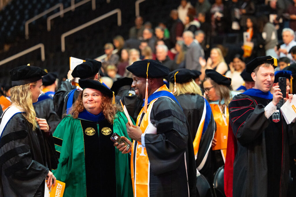 A group of faculty and new doctors in regalia after the ceremony.